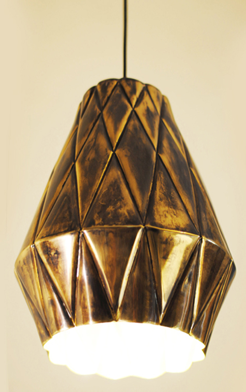 This beautifully handcrafted pendant lamp is a result of origami techniques of folding paper to create volume and texture like upholstered cushions. Since the form also resembles the surface of a pineapple, the lamp is named Ananas lamp
